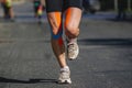 close-up legs male runner running dark asphalt in summer marathon race Royalty Free Stock Photo