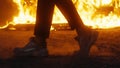 Man who dances a moonwalk against the background of a burning car