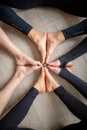 Close up legs of people sitting on the gym floor in a circle together.