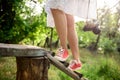 Close up of legs in red keds steping on desk. Royalty Free Stock Photo