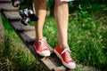 Close up of legs in red keds steping on desk. Royalty Free Stock Photo