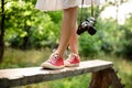Close up of legs in red keds steping on desk. Royalty Free Stock Photo