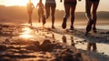 Close up legs runner group running on sunrise seaside trail.