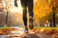 Close up legs of runner in park at autumn morning