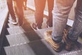 Modern businessman working close-up legs walking up the stairs in modern city. Royalty Free Stock Photo