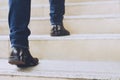 Close up legs shoes of young business man One person walking stepping going up the stairs