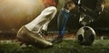 Close-up legs of soccer, football players in action, motion at the stadium with flashlights and crowded stands. Concept