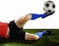 Close up legs and soccer shoe of football player in action doing tackle and kicking ball Royalty Free Stock Photo