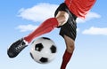 Close up legs and soccer shoe of football player in action outdoors kicking ball isolated on blue sky Royalty Free Stock Photo