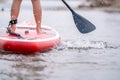 Close-up of legs Stand up paddle boarding on the river