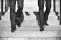 Close up legs of two businessman walking down stair in modern city Royalty Free Stock Photo