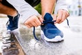 Close up of legs of unrecognizable runner, town, puddle