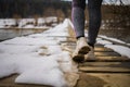 Legs in white sneakers on the road In Winter Forest. Royalty Free Stock Photo