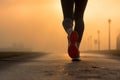 Close up on legs of a woman running on foggy morning after the rain. Runners legs on a sunrise