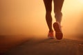 Close up on legs of a woman running on foggy morning after the rain. Runners legs on a sunrise