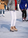 Close up with the legs of a woman with skates on ice. Ice skating recreational activity