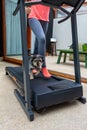 Woman exercising with her dog on a treadmill in the living room at home due to quarantine