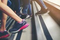 Close up legs of young Asian walking upstairs outside office in