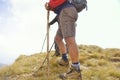 Close-up of legs of young hikers walking on the country path. Young couple trail waking. Focus on hiking shoes Royalty Free Stock Photo