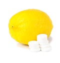 Close up of lemon and pills isolated - vitamin concept