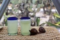 Close up lemonade in blown glass glass on table and desert vegetation in the background, glamping drink desert mexico