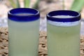 Close up lemonade in blown glass glass on table and desert vegetation in the background, glamping drink desert mexico