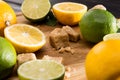 Close up of lemons and limes with brown sugar on wooden kitchen board