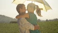 CLOSE UP: Cheerful young couple shares a romantic moment while dancing in rain. Royalty Free Stock Photo