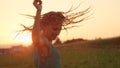 CLOSE UP Joyful blonde girl enjoys her evening in countryside by dancing in rain