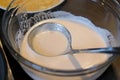 Close up of a lentils batter in glass bowl with a ladle