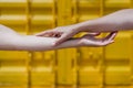 Close up of lesbian couple holding hands in front of yellow background. Love is love . LGBTI concept