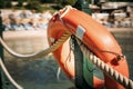 Close-up of a life buoy hanging on a fence near the sea on the beach Royalty Free Stock Photo