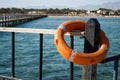 Close up of Lifebuoy on pillar. Orange Lifebuoy for safety on water. life save equipment for emergency on water.