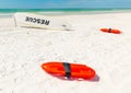 Close up of lifesavers and rescue surfboard on the sand