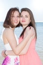 Lifestyle fashion portrait of two pretty fresh young lesbian best friends girls having vacation on tropical island beach