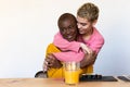 Close up lifestyle portrait of diverse multiracial happy best friends hugging each other and laughing indoor Royalty Free Stock Photo