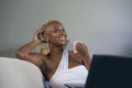 Close up lifestyle portrait of young classy attractive and happy black african american woman drinking coffee or tea working on la