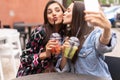 Close up lifestyle selfie portrait of pretty fresh young brunette best friends girls making selfie, having fun Royalty Free Stock Photo