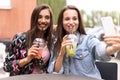 Close up lifestyle selfie portrait of pretty fresh young brunette best friends girls making selfie, having fun Royalty Free Stock Photo