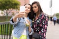 Close up lifestyle selfie portrait of pretty fresh young brunette best friends girls making selfie, having fun Royalty Free Stock Photo