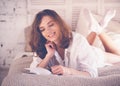 lifestyle soft image of pretty young woman sitting on her cozy Royalty Free Stock Photo