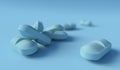 Close up of light blue medical tablets isolated on blue background