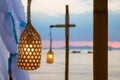 Close up of light bulb on the wire. Glow up In the lamp. Hanging on the beach, against the sunset sky and other lamp on a pole of