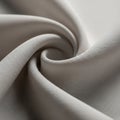 A close-up of a light gray fabric with a smooth, flowing twist pattern. The texture is visible, Royalty Free Stock Photo