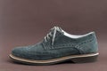 Close up of light green suede derby shoes on brown background Royalty Free Stock Photo