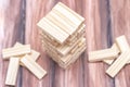 Close-up of a light wooden tower made of blocks. Board game Jenga on the table. Activity for strategy and concentration Royalty Free Stock Photo