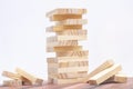 Close-up of a light wooden tower made of blocks. Board game Jenga on the table. Activity for strategy and concentration Royalty Free Stock Photo