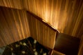 Close-up of the lighted wooden spiral staircase of the villa Royalty Free Stock Photo