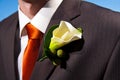 Close up of a lily corsage on a groom