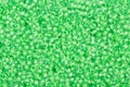 Lime green background seed beads. Royalty Free Stock Photo